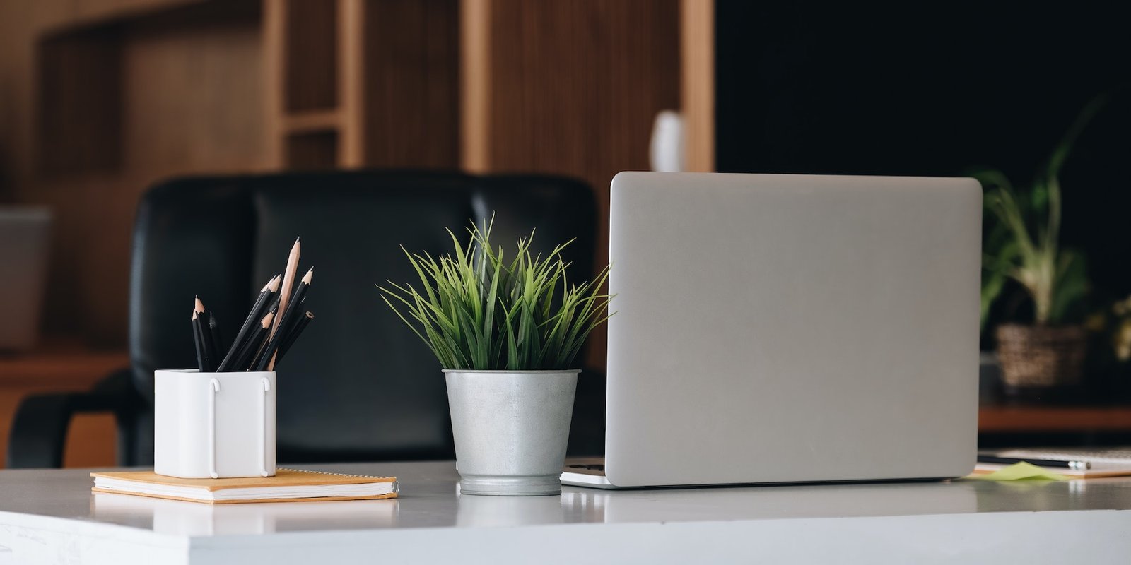 Laptop on office desk interior. Stylish workplace mockup